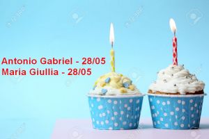 Delicious birthday cupcake on table on light blue background