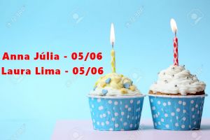 Delicious birthday cupcake on table on light blue background