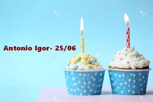 Delicious birthday cupcake on table on light blue background