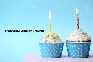 Delicious birthday cupcake on table on light blue background