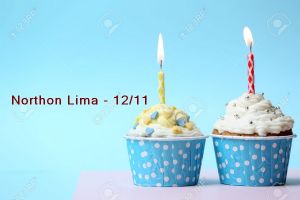 Delicious birthday cupcake on table on light blue background