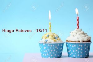 Delicious birthday cupcake on table on light blue background